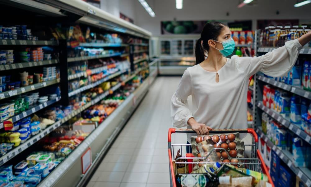 Woman buying groceries wearing a face mask.jpeg