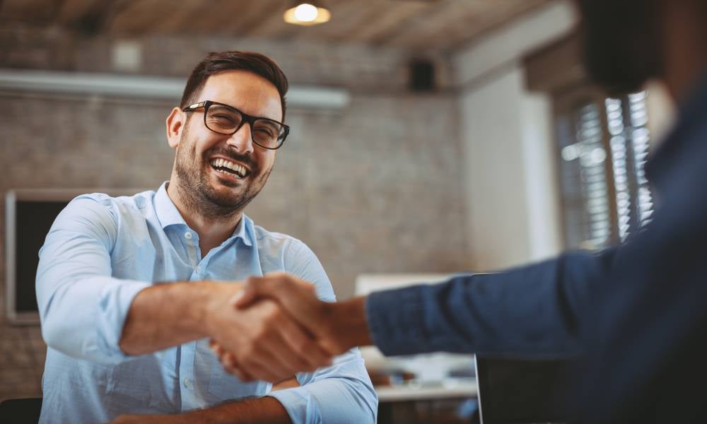 Small business owner shakes hands recovery plan during COVID-19 pandemic.jpeg