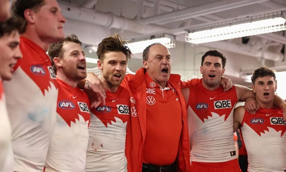 John Longmire, former head coach of the Sydney Swans, with players post-match.jpg