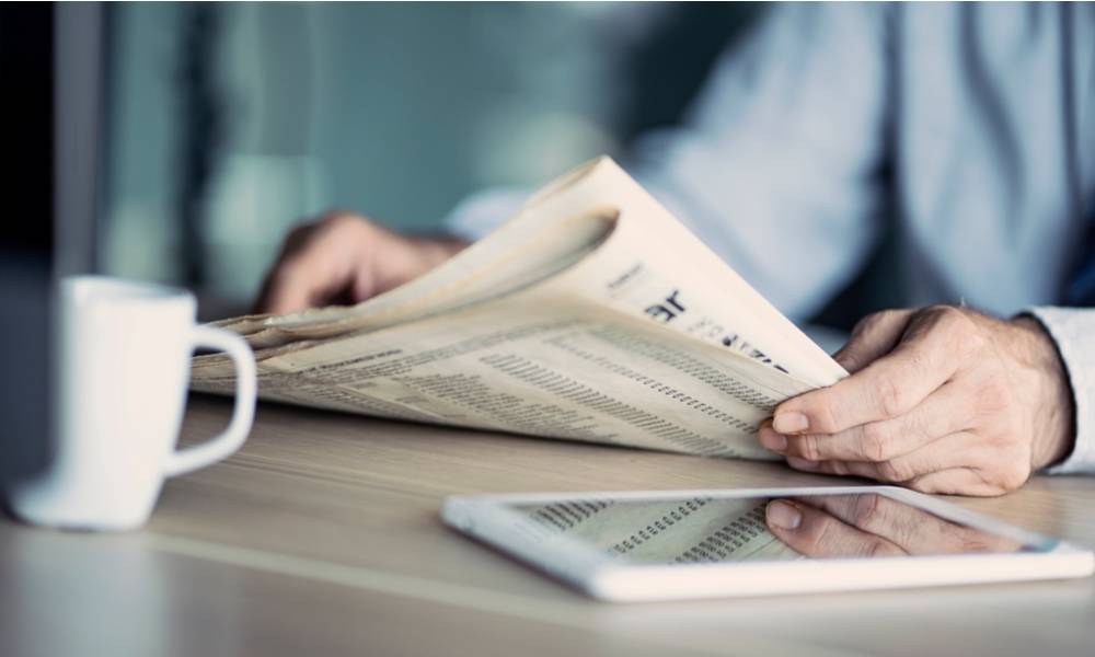 Businessman reading the newspaper on table (1).jpg