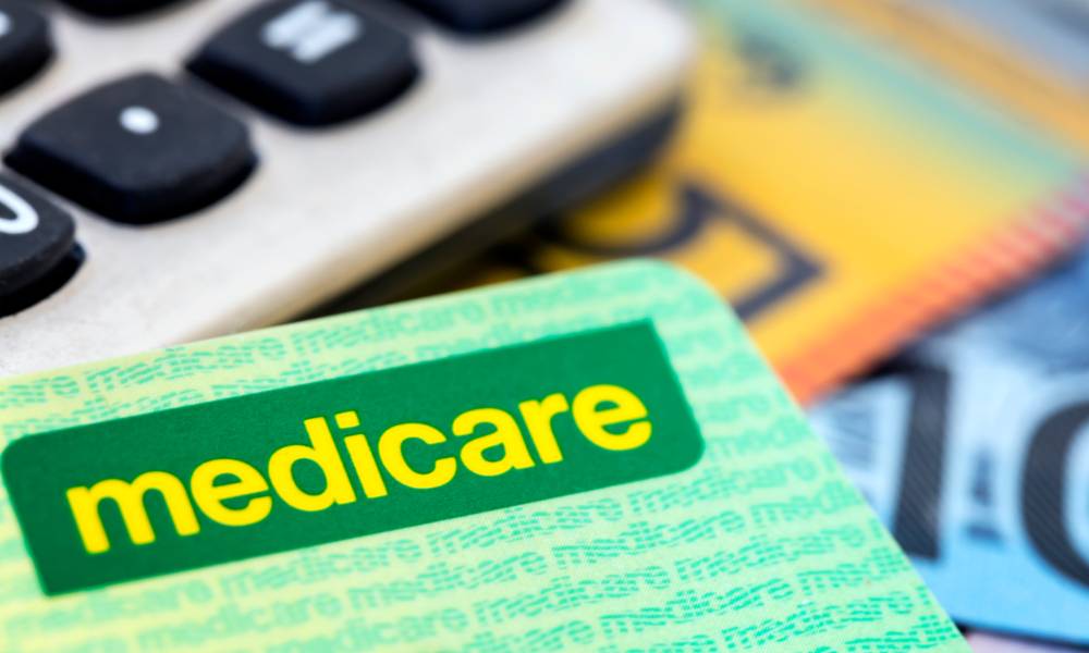 Australian Medicare card with calculator and cash background.jpg