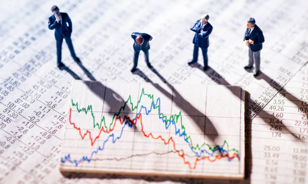 Puzzled men in suits crowded around a stock chart (1).jpg