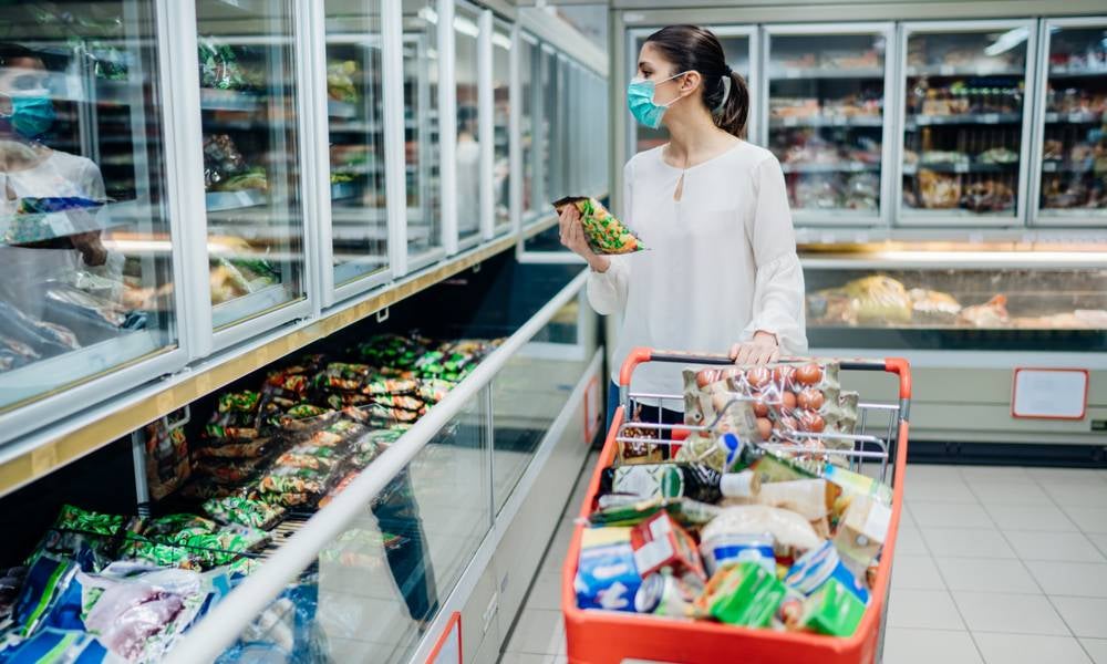 Woman face mask shopping inflation prices wage growth tax rises.jpeg