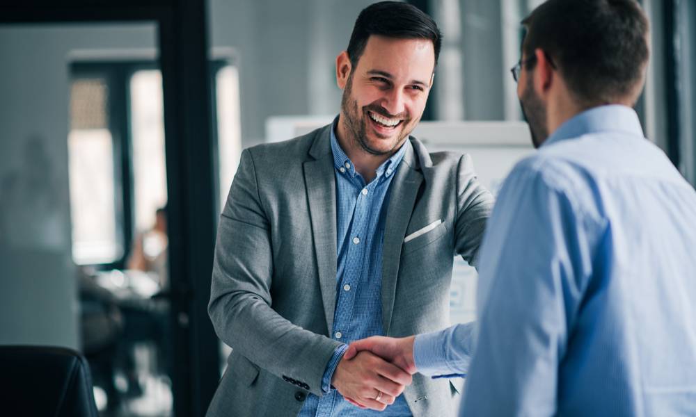 Businessman shaking hands with happy client (1).jpg