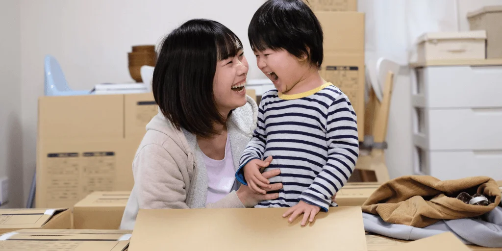 Parent and child smiling at each other.