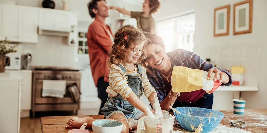 Family having fun baking together in the kitchen