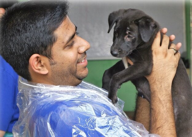 person holding a dog and smiling