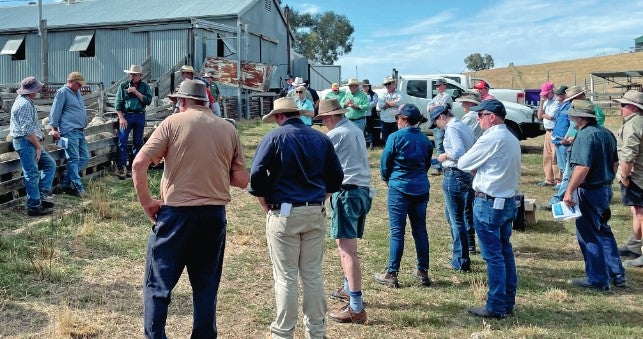 Farmers outside of a shed