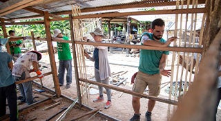 group of people building a wall together
