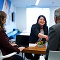 close up of a woman smiling shaking a mans hand