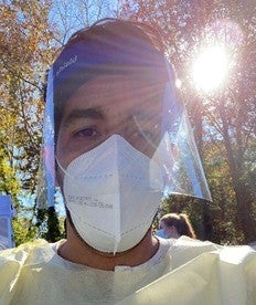 Garcia wears protective clothing as he waits outside a COVID-19 testing facility in Atlanta to help coordinate Spanish-speaking Georgians in underserved communities to get tested for the virus.