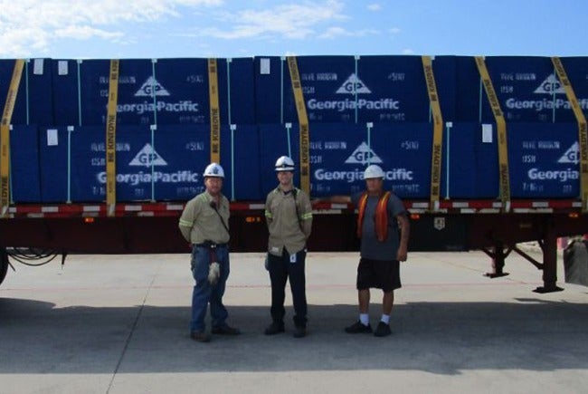 From left to right: Matthew Bynog (Shipping Coordinator), Jon Cook (Production Manager), Truck Driver delivering the shipment.