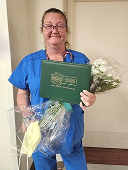 Sue Phillips holding flowers