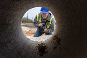 Jim Knerr in tunnel holding camera