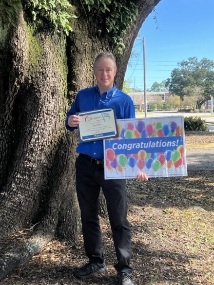 Jim Knerr holds up his award sign after being recognized as Champion.