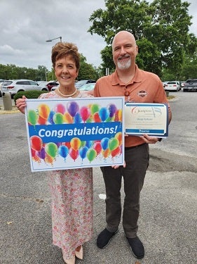 Penny poses with Doug when he's awarded Champion.