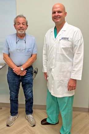 Patient Wilder is standing next to Dr. Lewis during appointment.