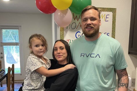 ECMO patient Jack Kuzmin smiling with wife and daughter.