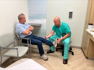 Patient Wilder shows mobility of leg after surgery with Dr. Lewis