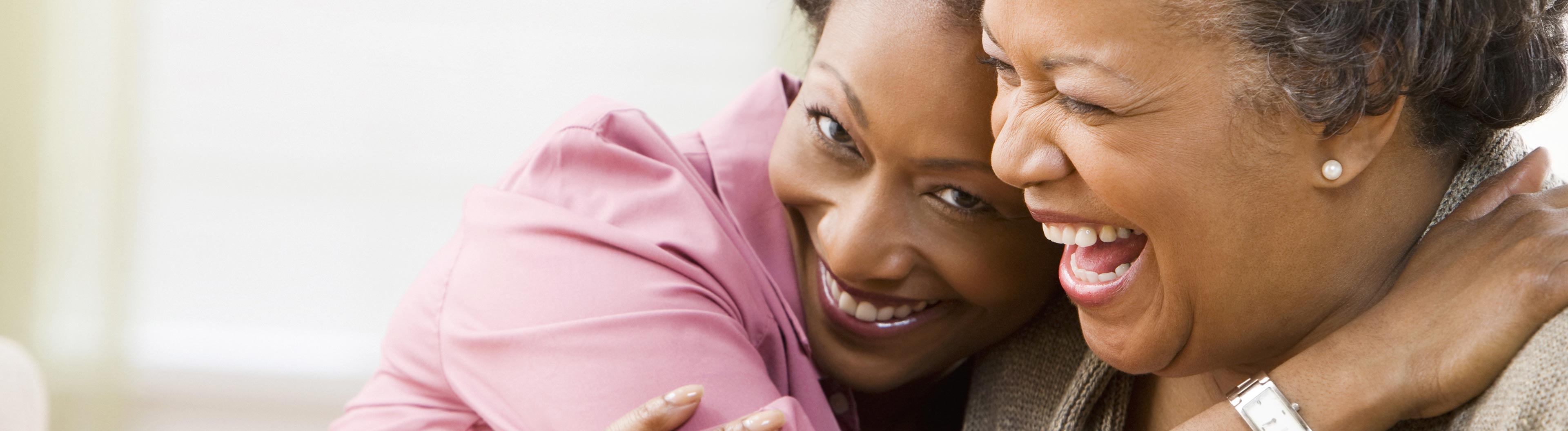 Woman hugging each other while laughing