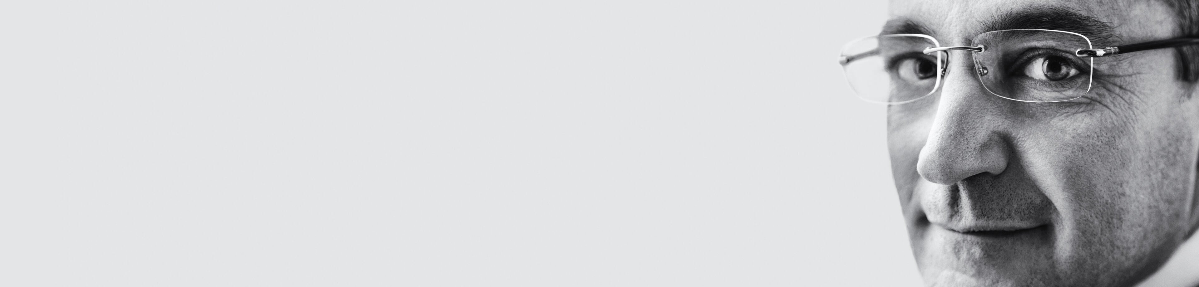 man with glasses in black and white