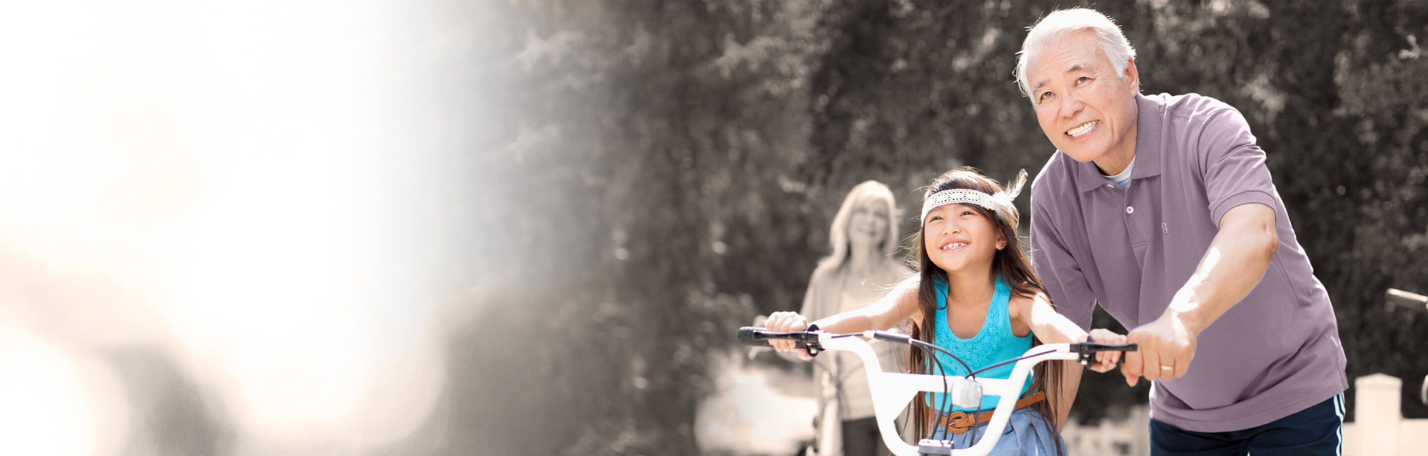 Man pushing girl on bike