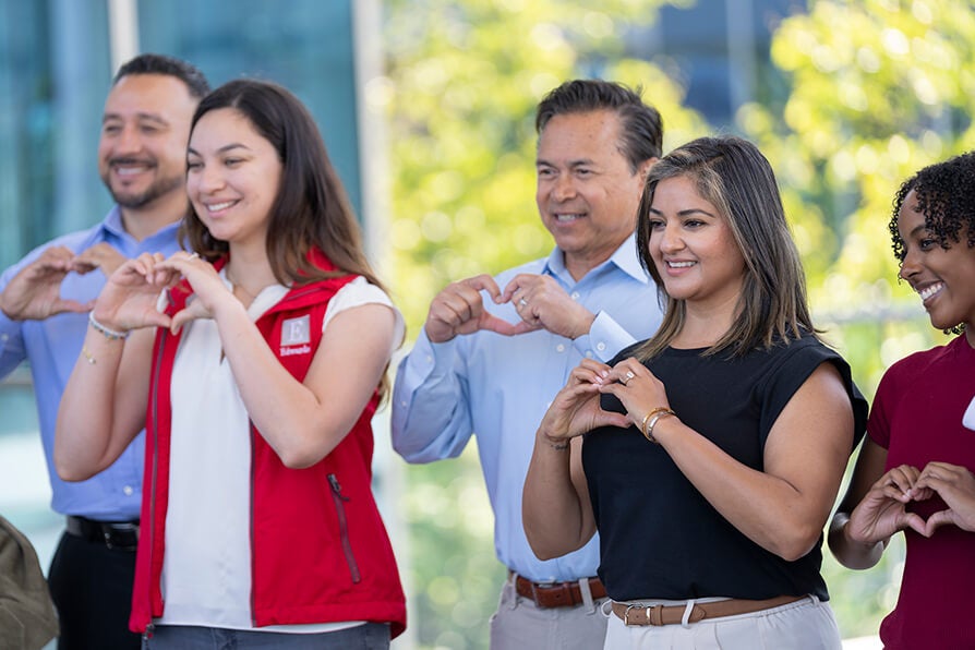Edwards employees making heart sign