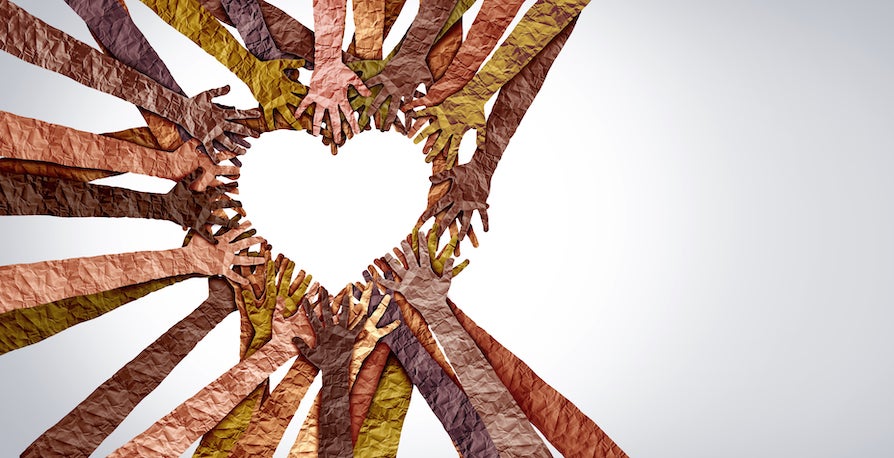 Paper hands coming together to form a heart