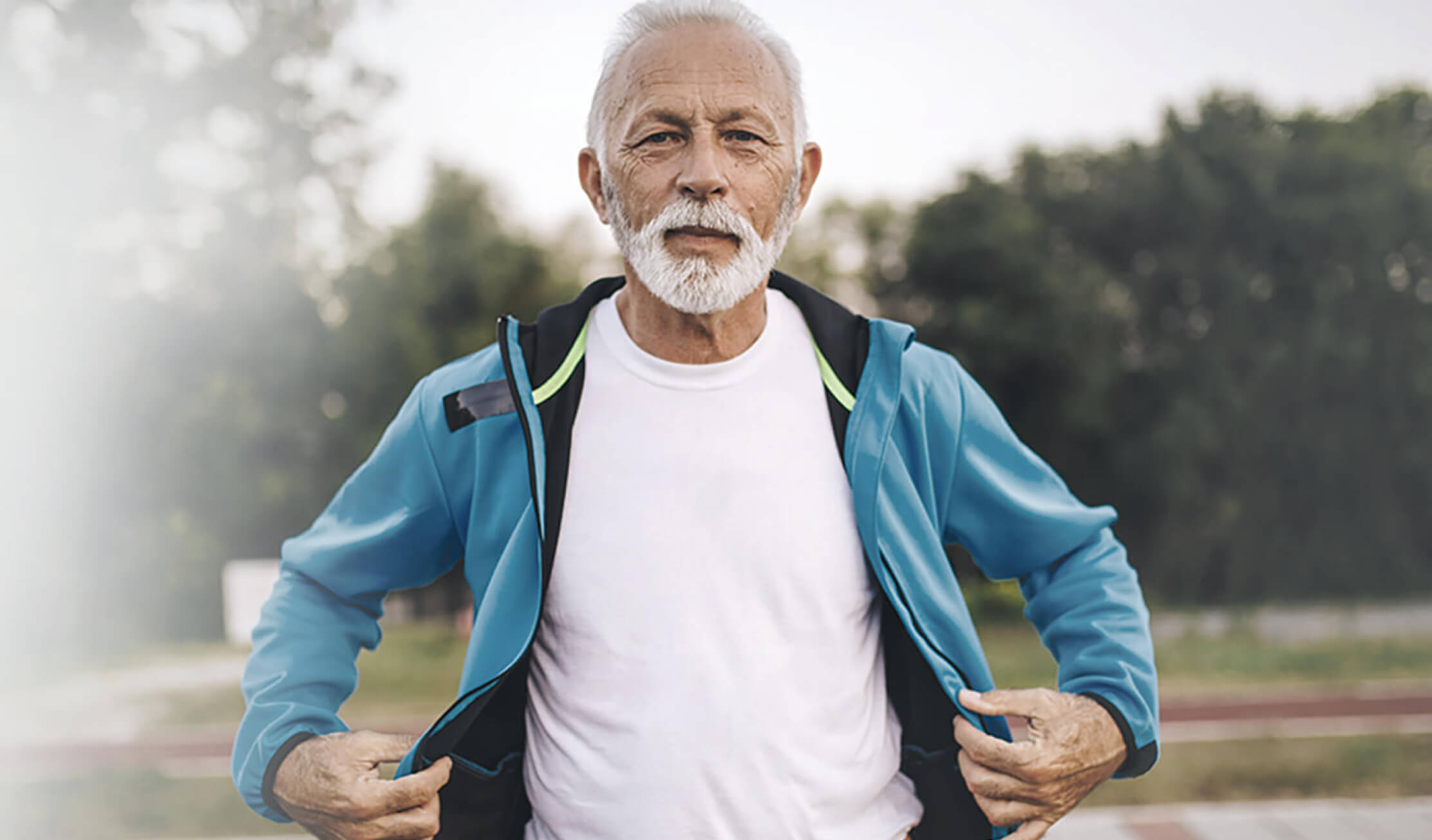 Elderly man with white tshirt and blue sweater