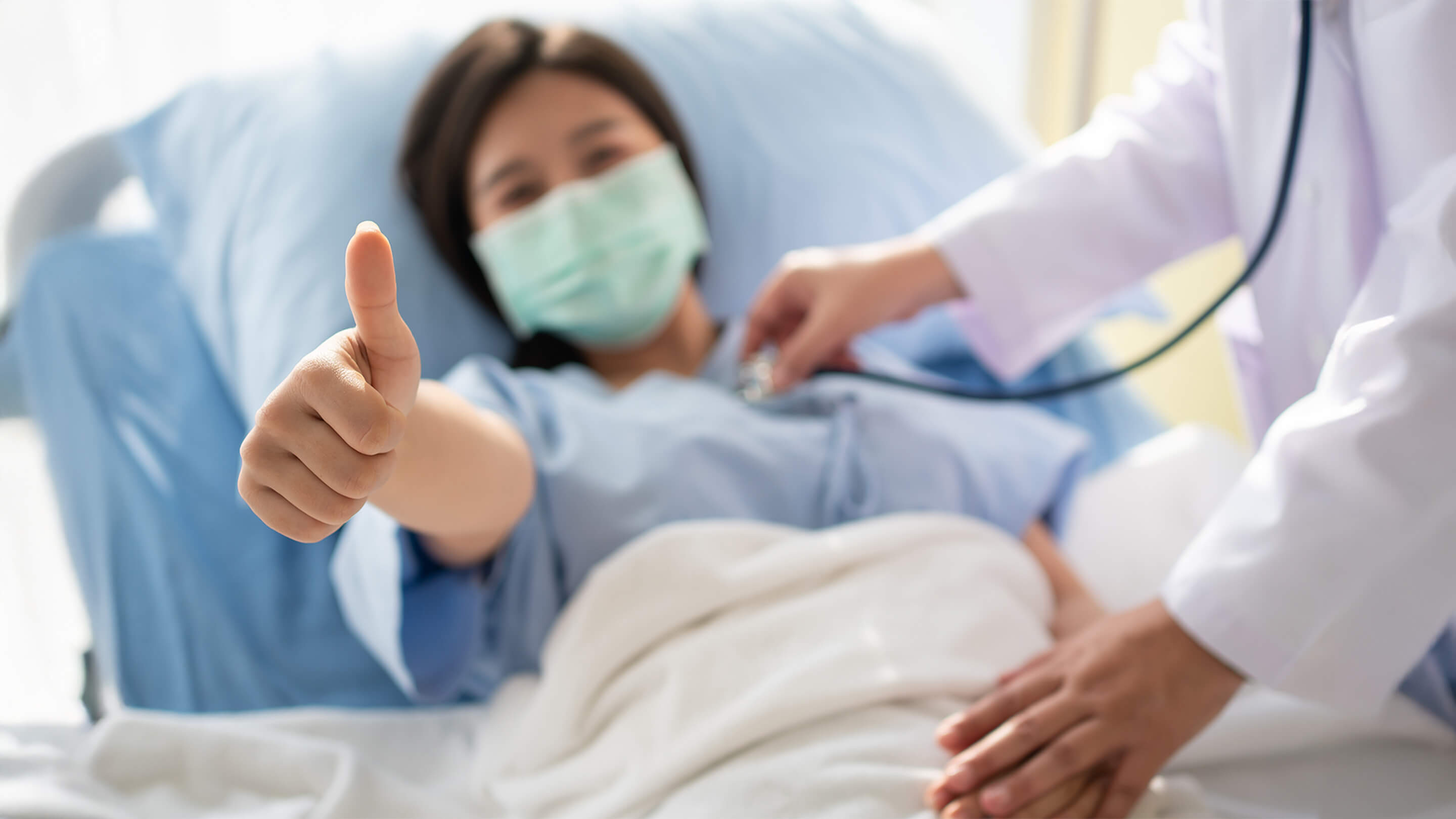 patient showing thumbs up