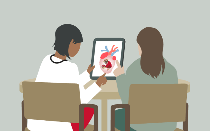 Healthcare professional sharing information with patient on tablet