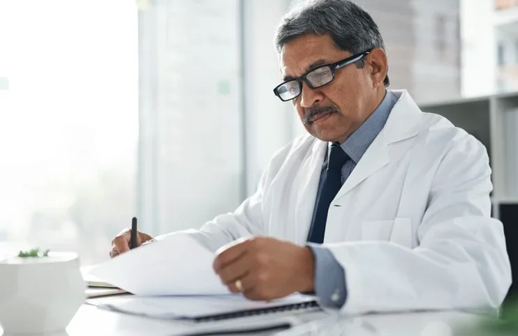 Doctor looking at chart