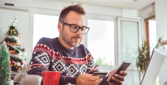 Man using credit card on phone during the holidays