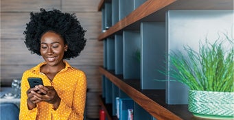 Image of woman smiling at her phone 