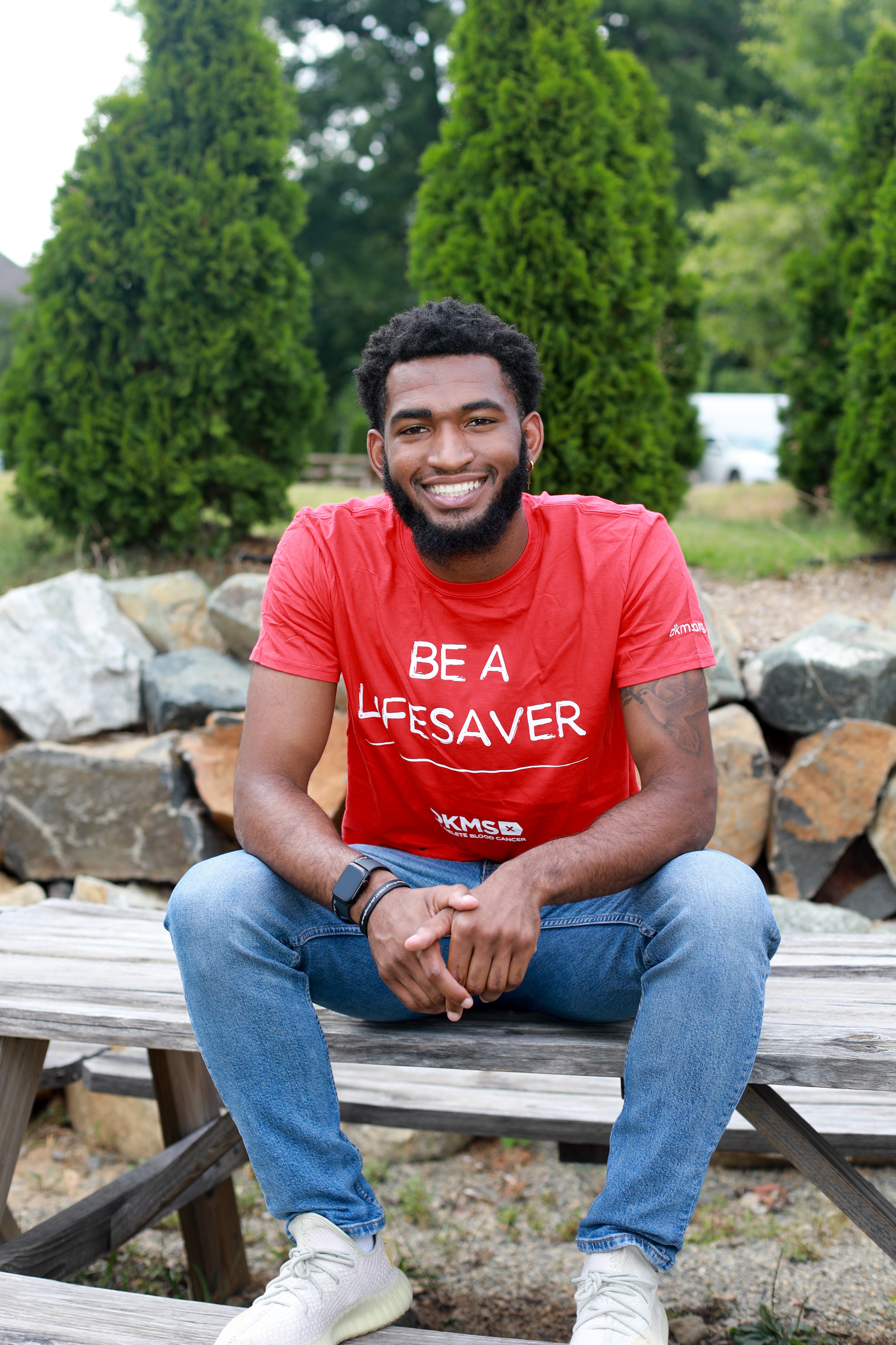 Corey, a registered bone marrow donor, smiles at a donation recruitment event