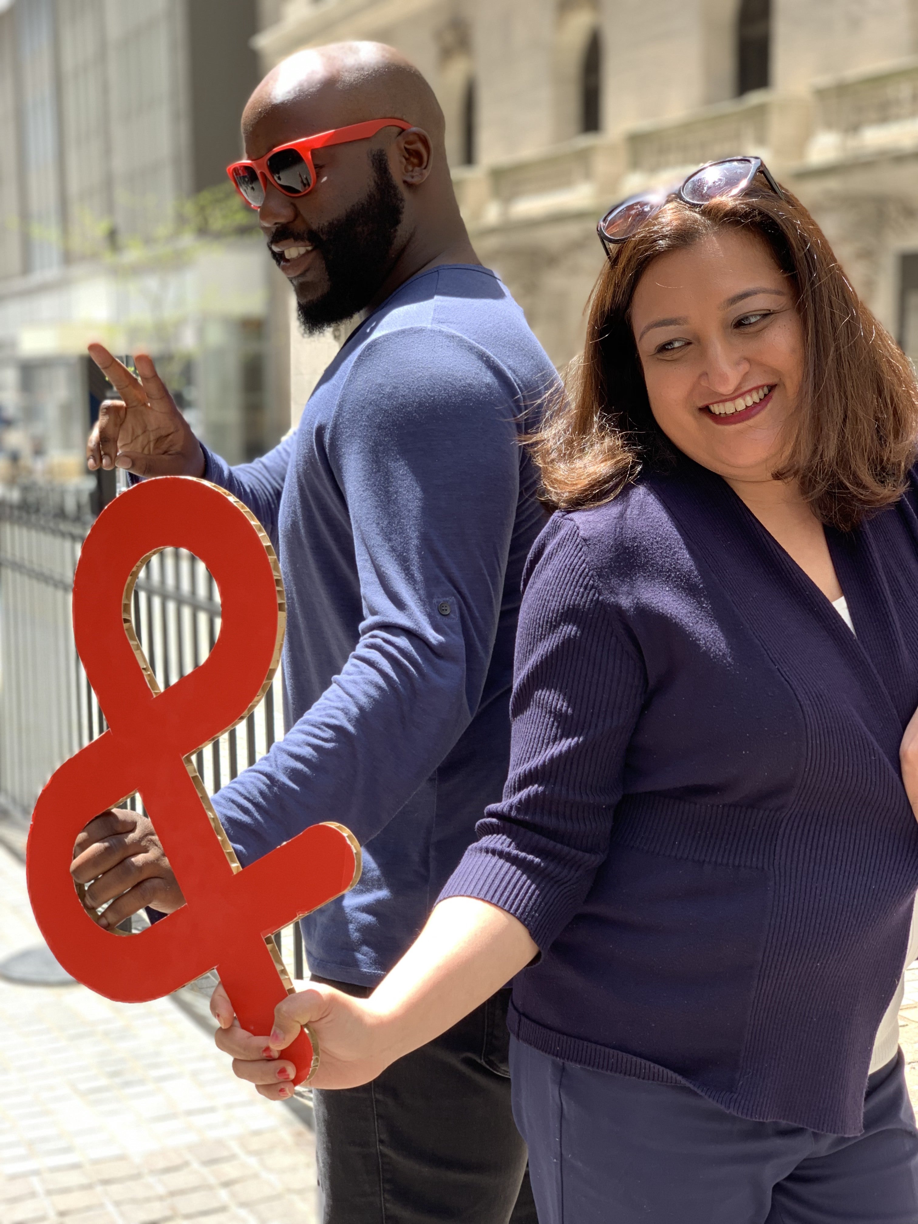 Two individuals with the official sign of WBCD, the red ampersand