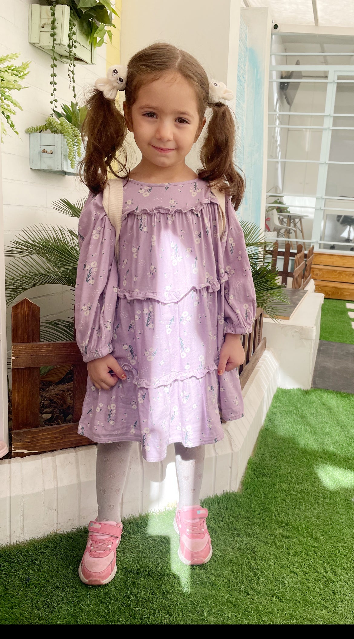 DKMS patient Nila wearing a purple dress and her hair in pigtails