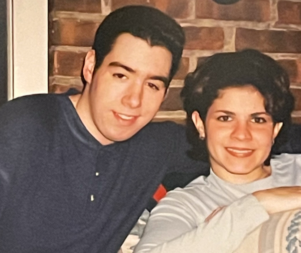 Michael sitting with his arm around Alyson sitting on the left. 