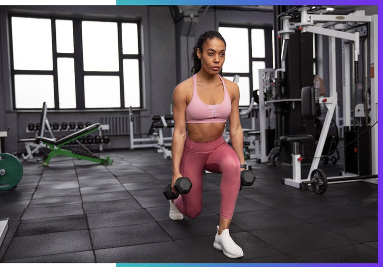 A woman is at the gym getting her form right. 