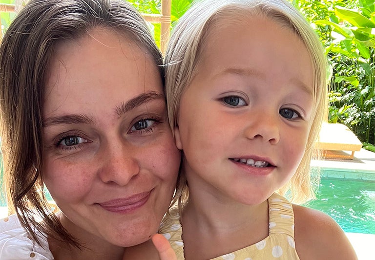 A woman and a child posing for a selfie