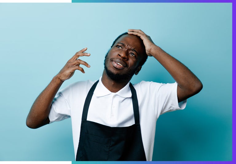 A man confused in the kitchen. 