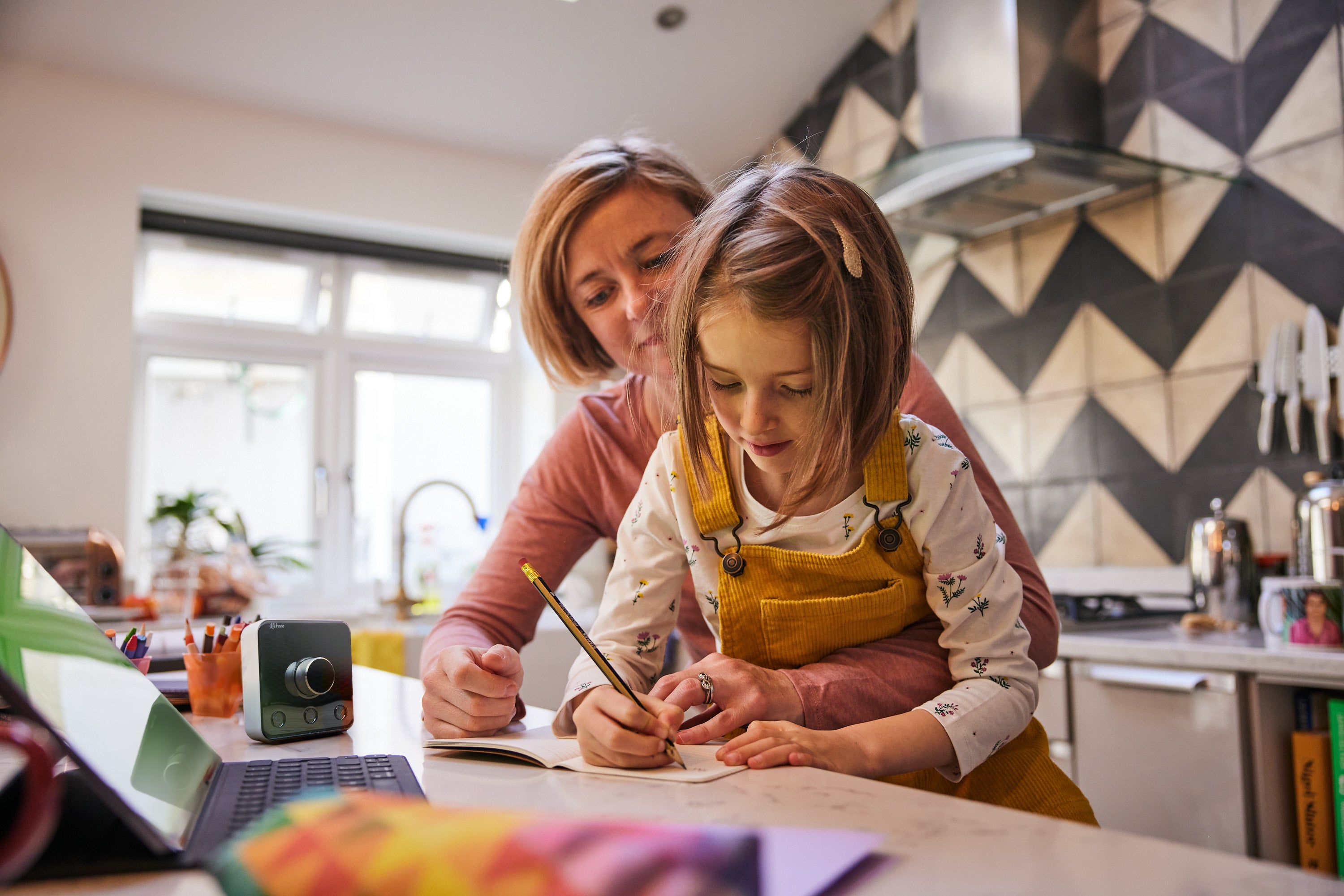 Woman and daughter writing