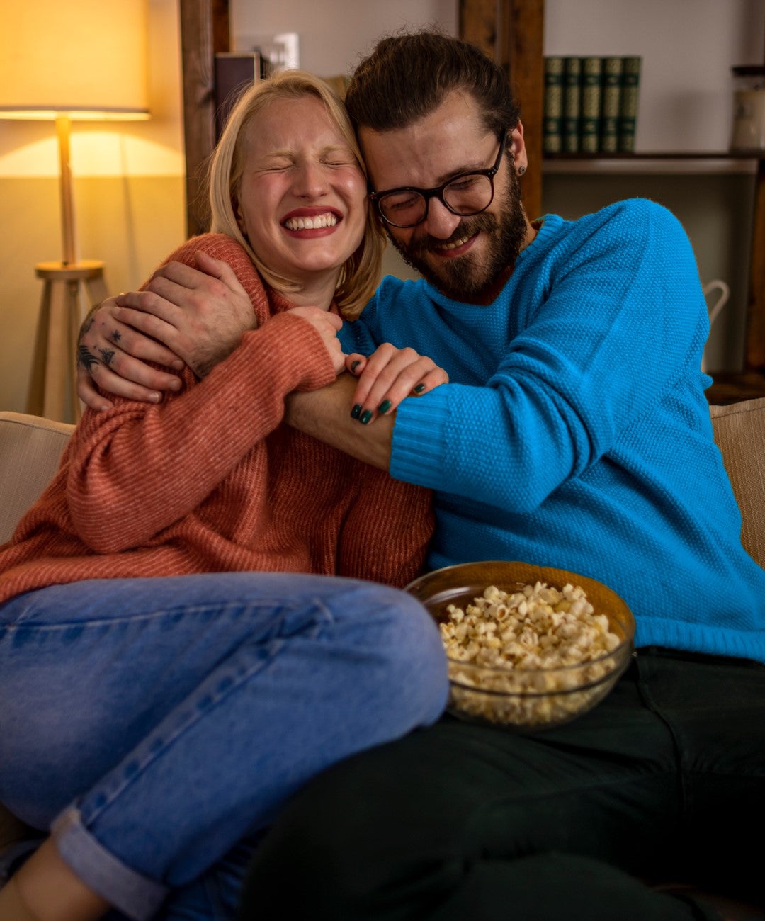 Man and woman hugging on couch 