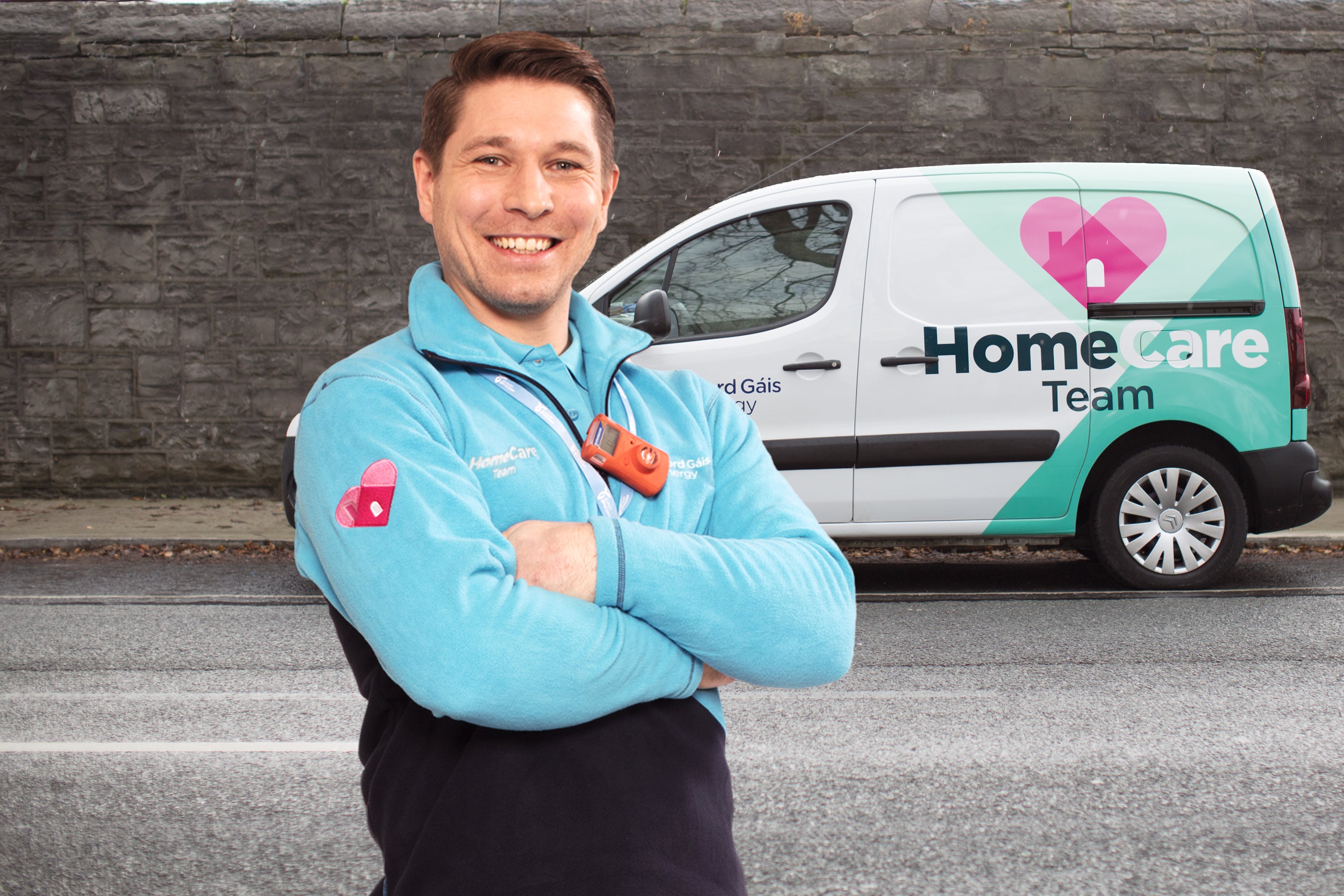 Bord Gáis Energy Boiler Service Engineer standing with arms crossed, smiling in front of HomeCare van.