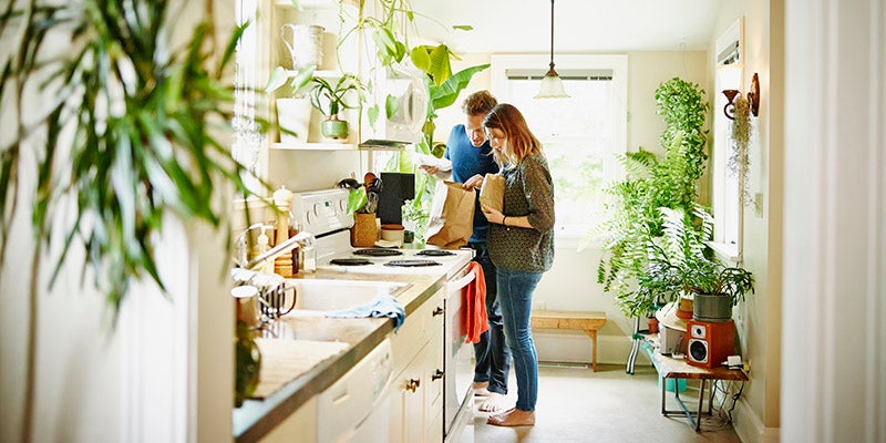 Couple in kitchen with plants