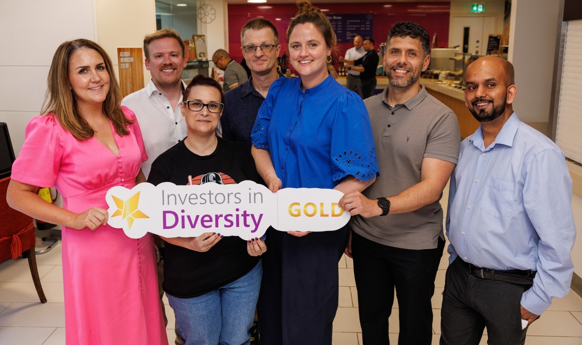 Bord Gáis Energy staff members holding a sign related to the achievement of Investors in Diversity Gold Accreditation