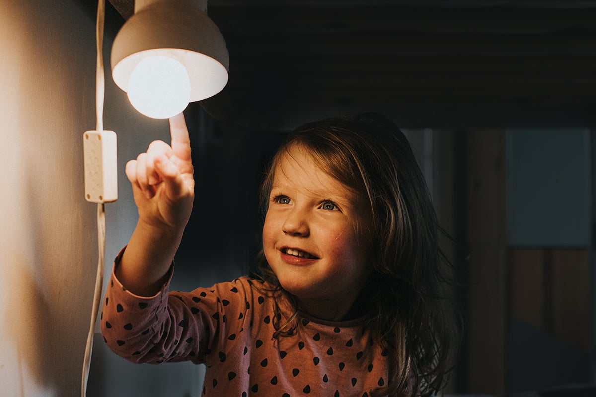 Child touching lightbulb