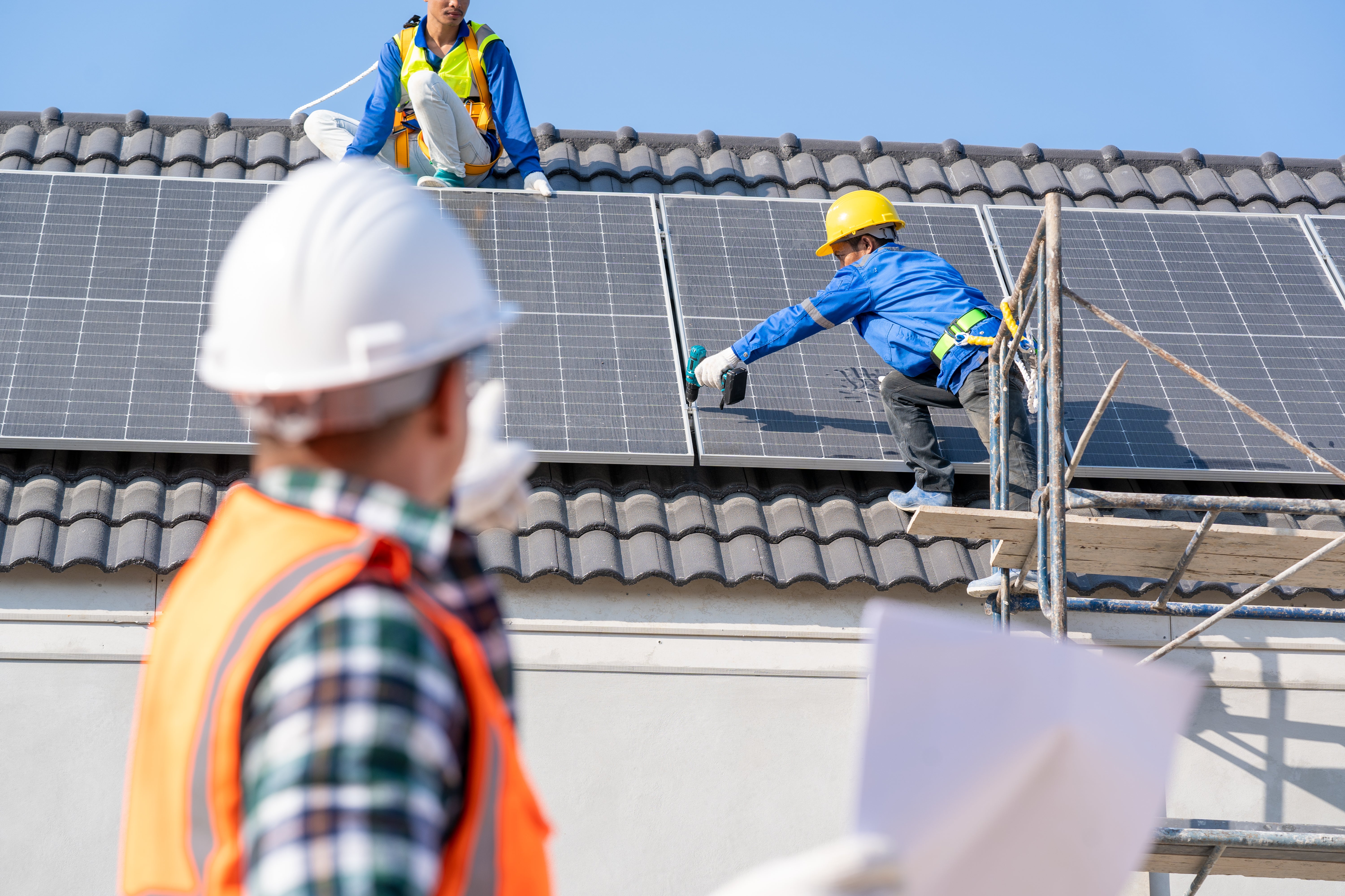 Engineer and electrician team swapping and install solar panel