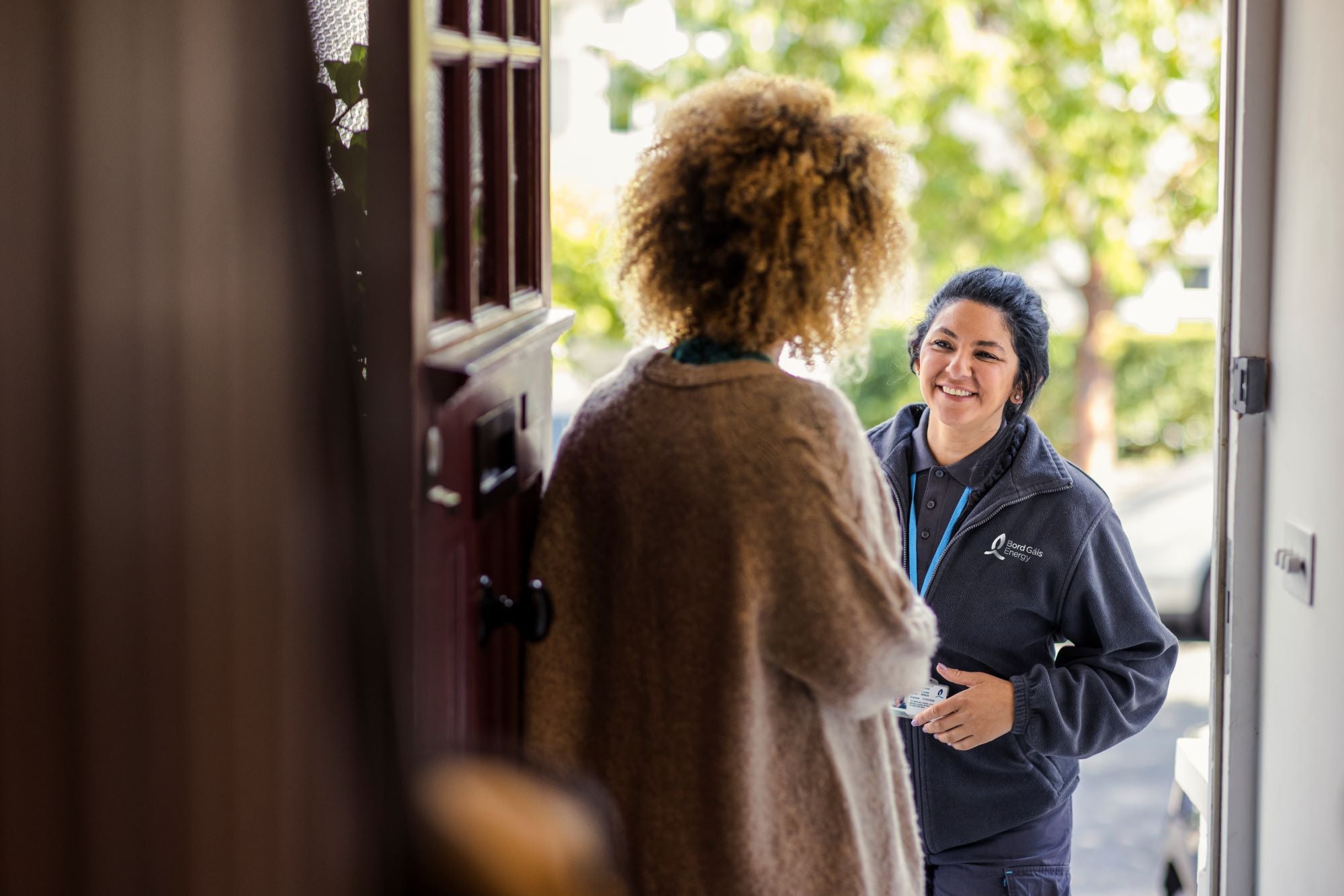 Woman opening door to engineer