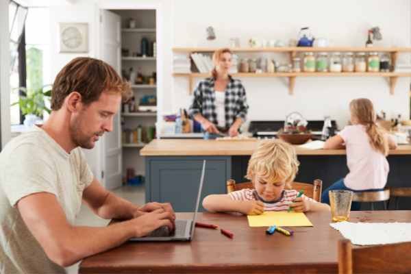Parents in kitchen with two children